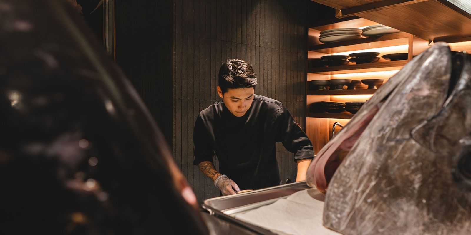 Tom at Tozen Sushi Bar with Tuna Heads in foreground