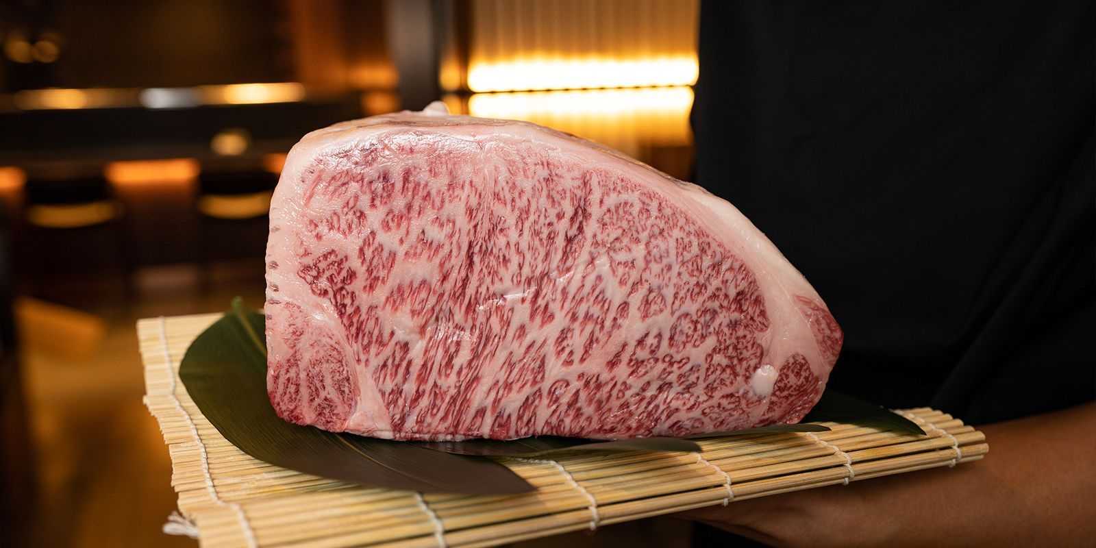 Wagyu beef held by chef tom jeon at Tozen Sushi Bar